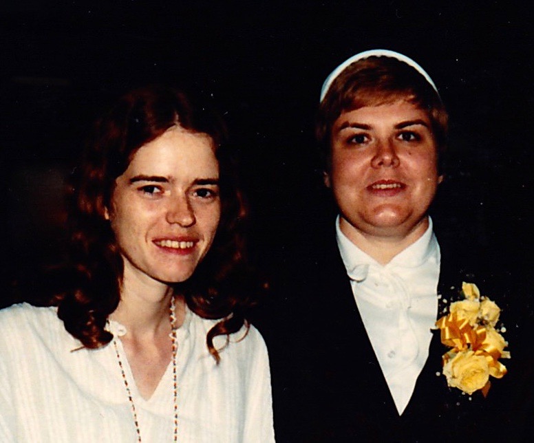 Myke and Lori, 1977, two of us standing close together, smiling. Lori is wearing a veil on taking her first vows as a Franciscan Sister.